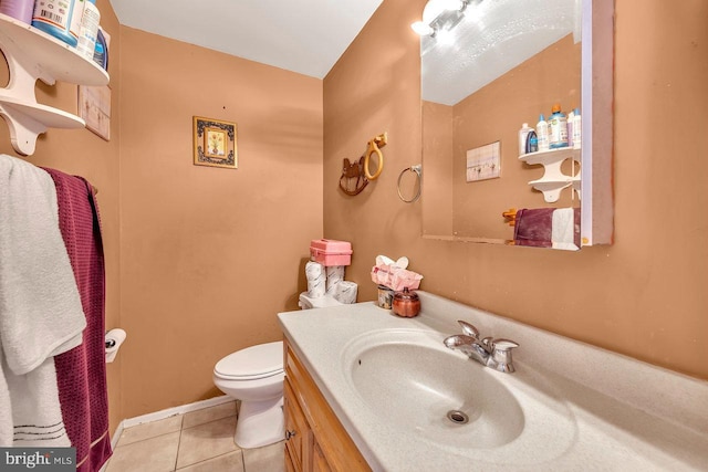 bathroom with tile patterned flooring, vanity, and toilet