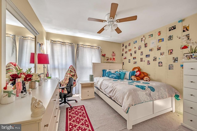 bedroom featuring ceiling fan and light carpet