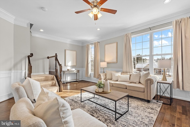 living room with dark hardwood / wood-style flooring, a wealth of natural light, and ornamental molding