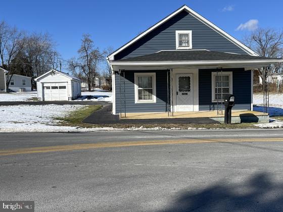 view of front of property featuring a porch, an outbuilding, and a garage