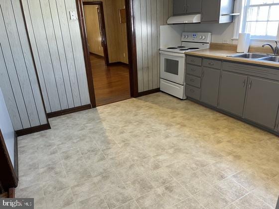 kitchen featuring white range with electric stovetop, gray cabinetry, and sink