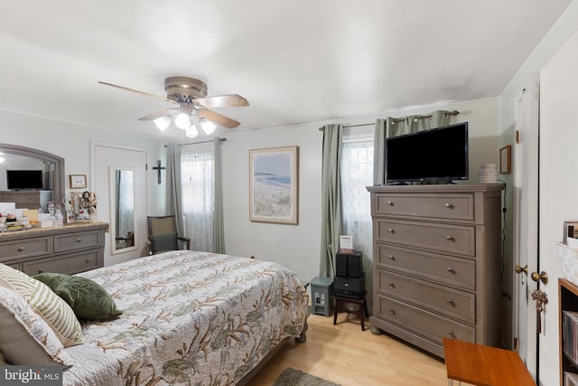 bedroom featuring multiple windows, ceiling fan, and light hardwood / wood-style floors