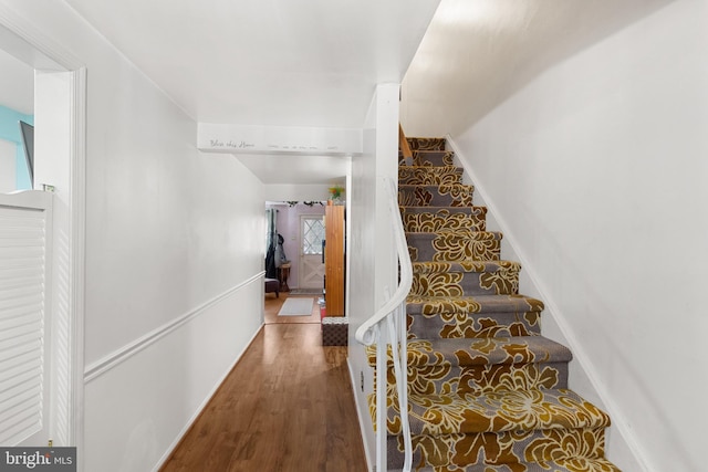 stairs with hardwood / wood-style floors