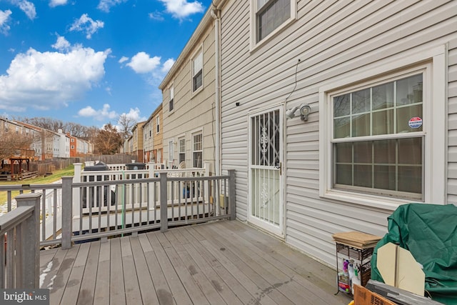 wooden deck featuring area for grilling