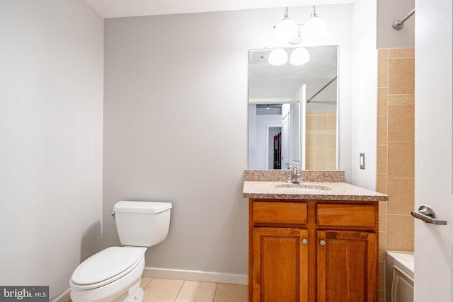 bathroom featuring vanity, tile patterned floors, and toilet