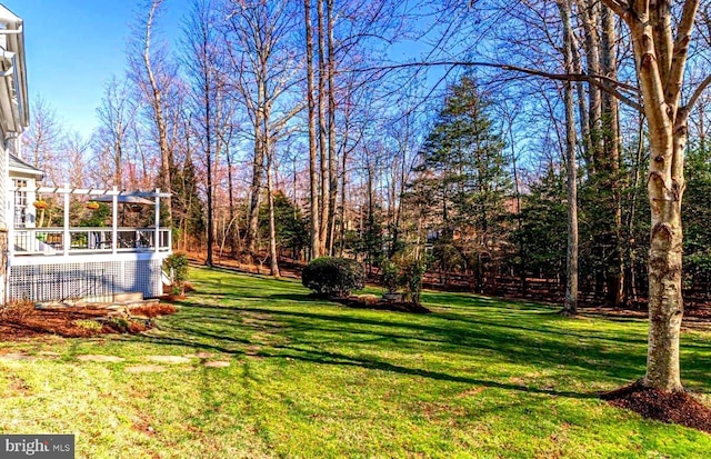 view of yard with a pergola and a deck