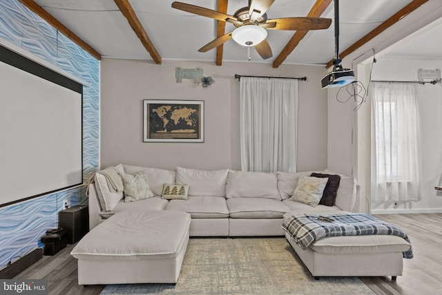 living room featuring hardwood / wood-style flooring, ceiling fan, and beam ceiling