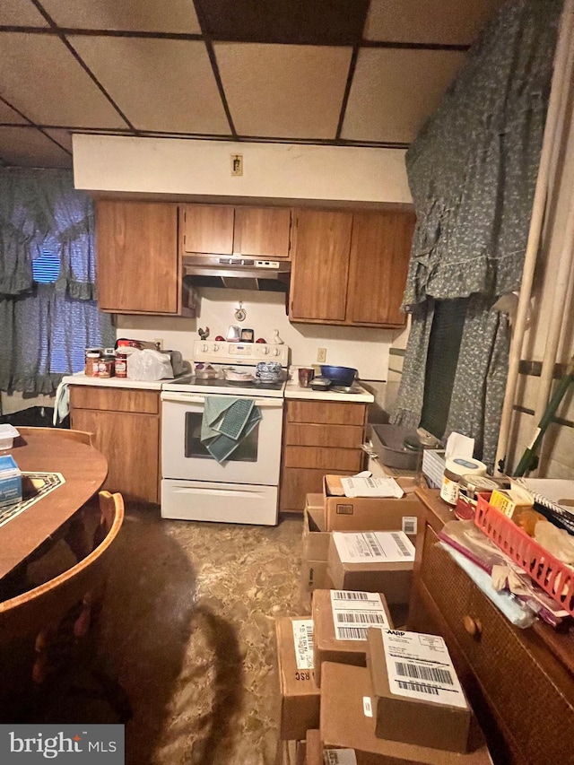 kitchen featuring a drop ceiling and white electric stove