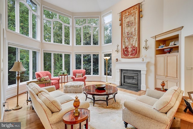 sunroom featuring a tile fireplace