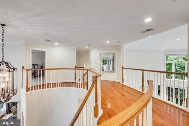 corridor featuring recessed lighting, visible vents, an inviting chandelier, an upstairs landing, and light wood-type flooring