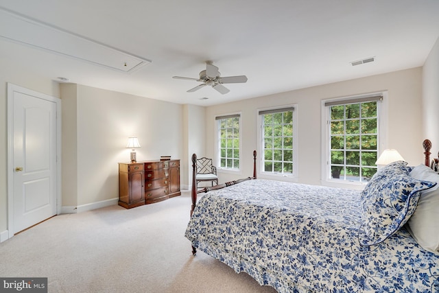 bedroom with ceiling fan, carpet floors, visible vents, baseboards, and attic access