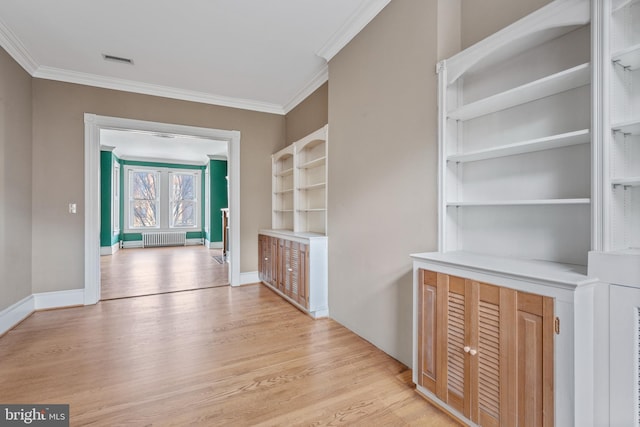 interior space featuring light wood-type flooring, radiator heating unit, and ornamental molding