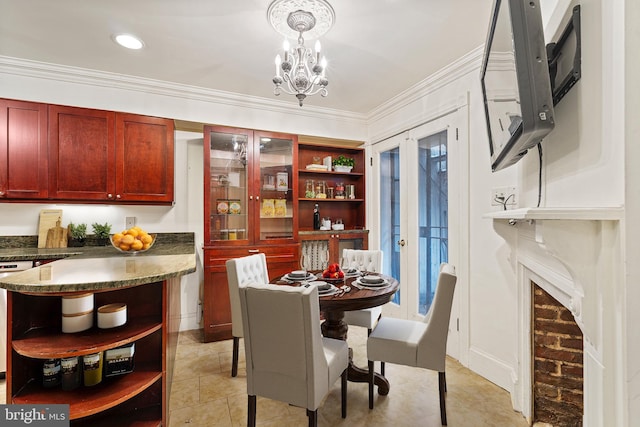 dining area featuring french doors, a notable chandelier, and ornamental molding