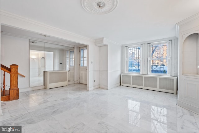 unfurnished living room featuring radiator heating unit and ornamental molding