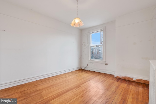 unfurnished room with hardwood / wood-style flooring