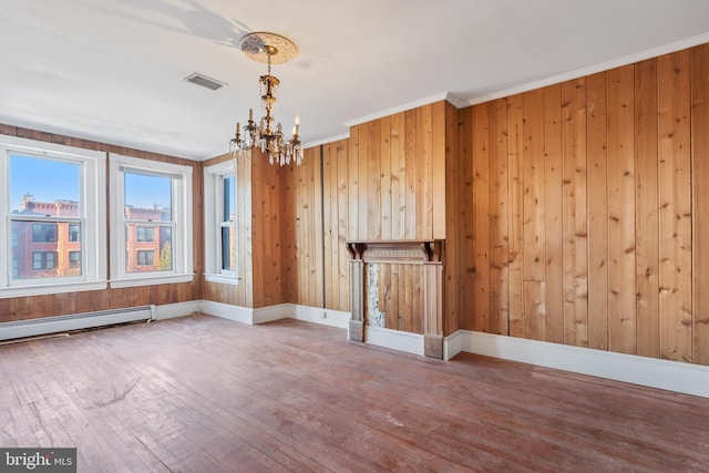 interior space featuring a baseboard radiator, hardwood / wood-style floors, a chandelier, and ornamental molding