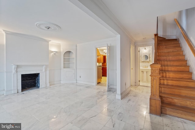 unfurnished living room with built in shelves, crown molding, and a fireplace