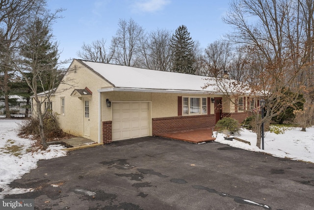 ranch-style home featuring a garage