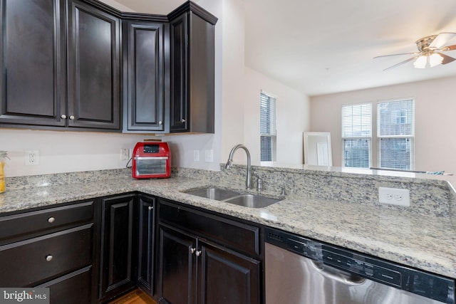 kitchen with ceiling fan, dishwasher, light stone counters, and sink