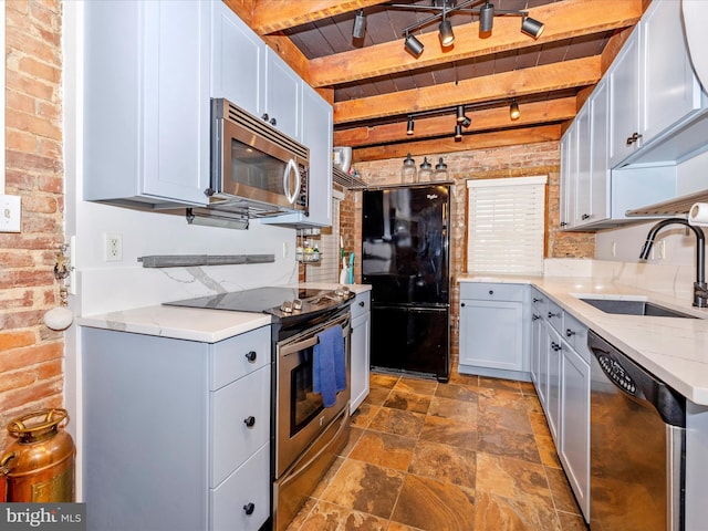 kitchen with sink, beamed ceiling, brick wall, wood ceiling, and appliances with stainless steel finishes