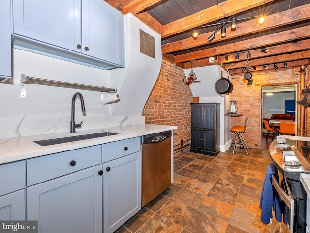 kitchen featuring brick wall, light stone counters, beam ceiling, sink, and stainless steel dishwasher