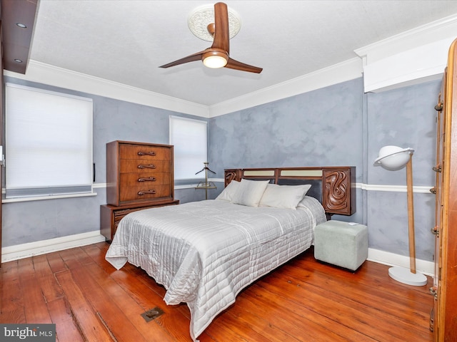 bedroom with ceiling fan, dark hardwood / wood-style flooring, and ornamental molding