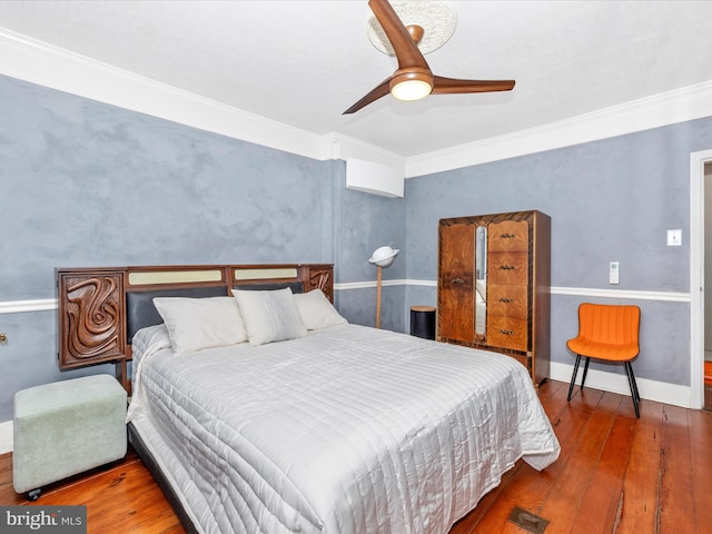 bedroom featuring ceiling fan, crown molding, and hardwood / wood-style floors