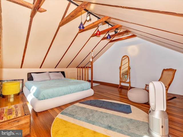 bedroom with hardwood / wood-style floors and vaulted ceiling