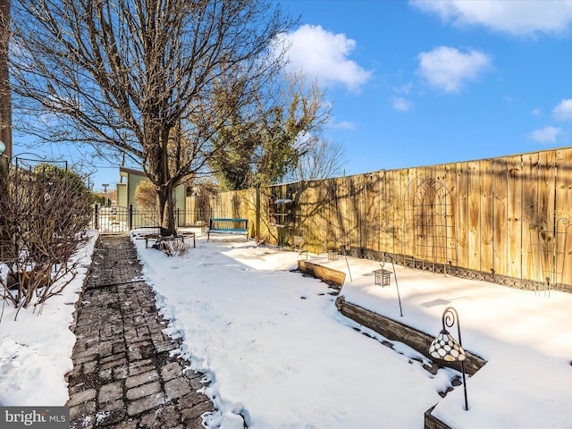 yard covered in snow featuring a hot tub