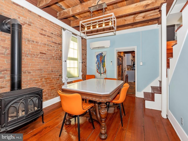 dining room featuring a wall mounted AC, brick wall, wood ceiling, wood-type flooring, and beamed ceiling