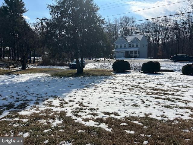 view of yard layered in snow