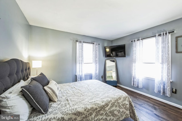 bedroom with dark hardwood / wood-style flooring