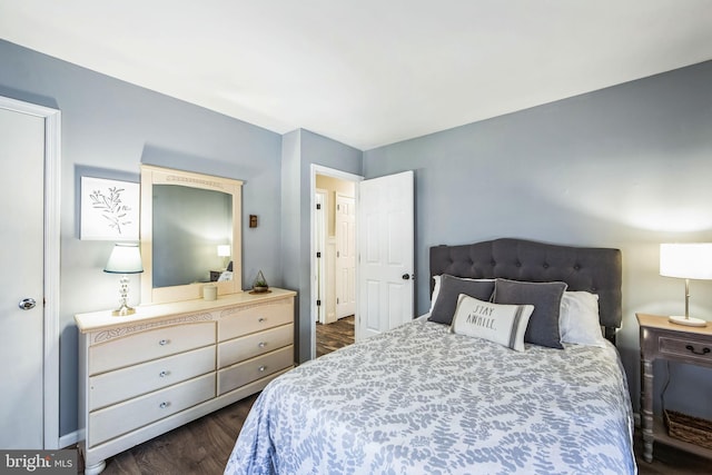 bedroom with dark hardwood / wood-style flooring