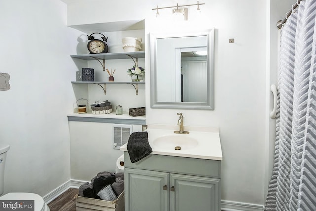 bathroom featuring toilet, hardwood / wood-style flooring, a shower with shower curtain, and vanity