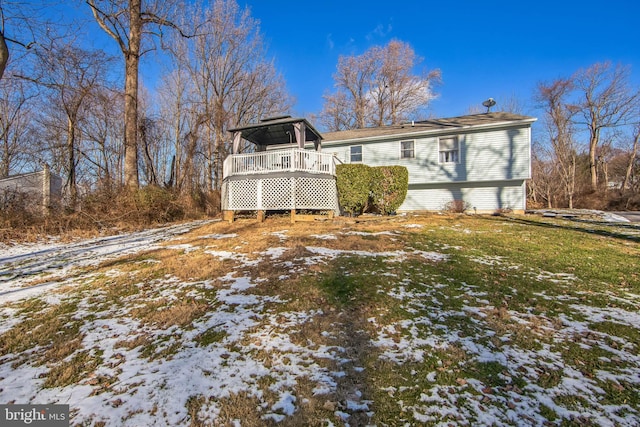 snow covered house with a gazebo and a wooden deck