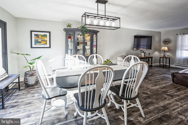 dining room with baseboard heating and hardwood / wood-style flooring