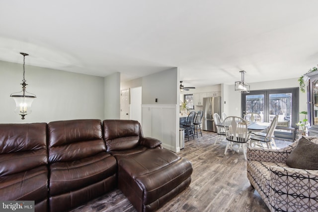 living room featuring ceiling fan and hardwood / wood-style floors