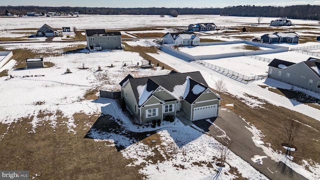 snowy aerial view featuring a rural view