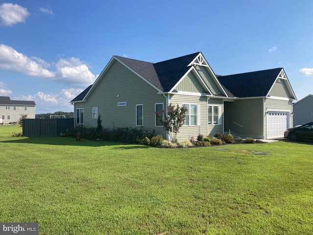 view of home's exterior featuring a lawn and a garage