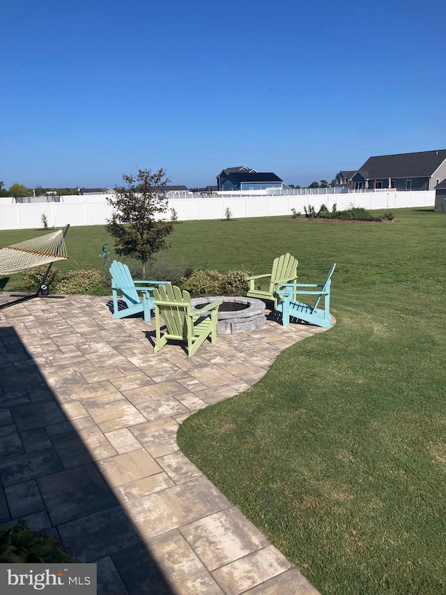 view of yard featuring an outdoor fire pit and a patio