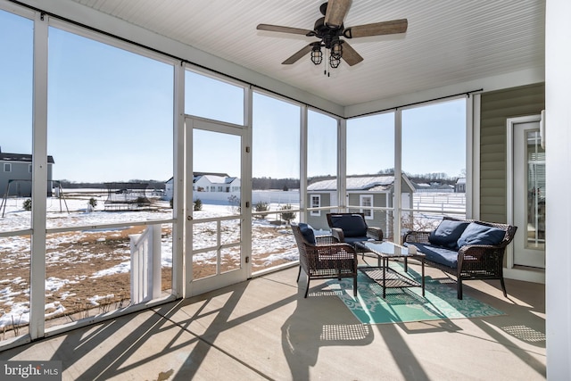 sunroom featuring ceiling fan