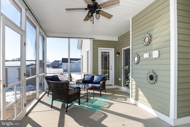 sunroom featuring ceiling fan and plenty of natural light