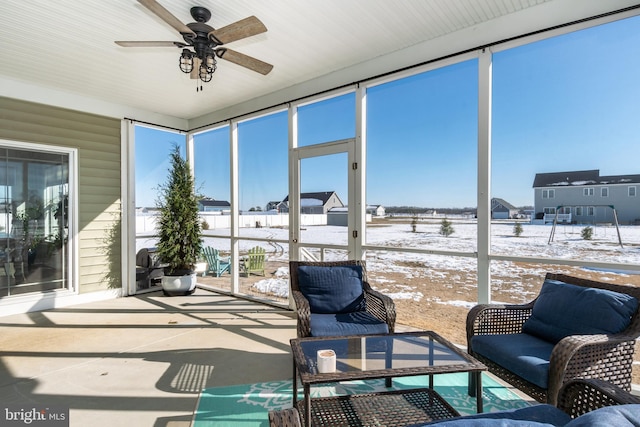 sunroom featuring ceiling fan