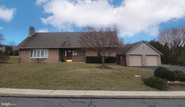 single story home with a front yard and a garage