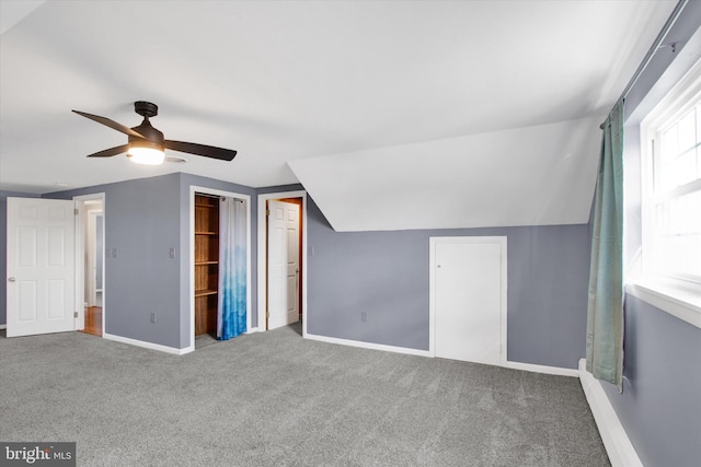 additional living space with vaulted ceiling, carpet, and ceiling fan