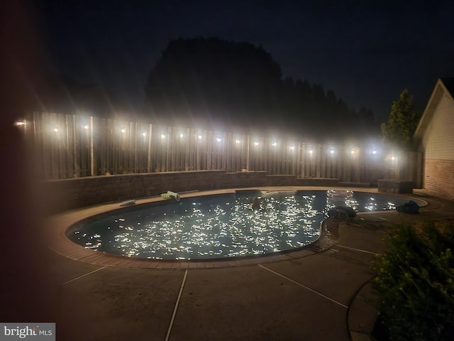 view of pool at night