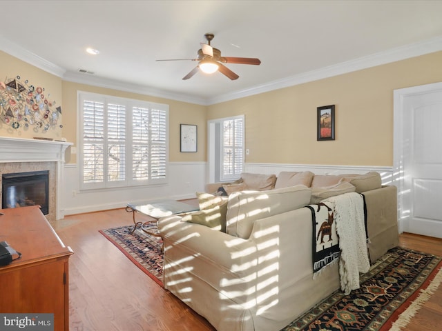 living room with ceiling fan, hardwood / wood-style flooring, and crown molding