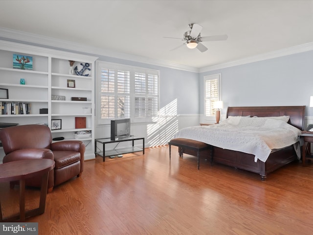 bedroom featuring ceiling fan, crown molding, and hardwood / wood-style flooring