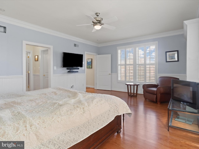 bedroom with ceiling fan, crown molding, and hardwood / wood-style flooring