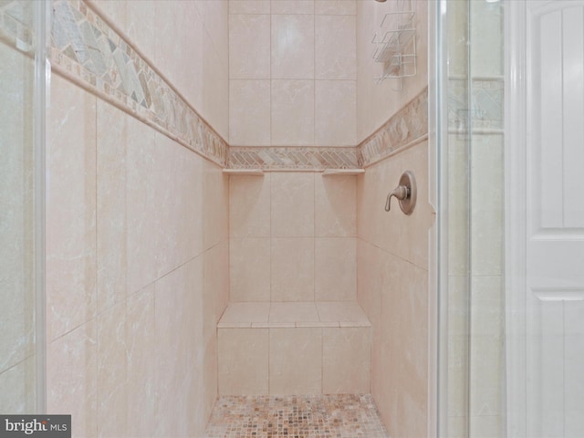 bathroom with a tile shower